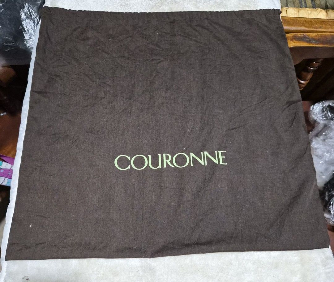 Couronne Brown Dust Bag (Category: Baby Monitors) located in Mandaue City. Submitted by chuchi152615 (Listing ID 1462791423, Image 3). Description: Brown dust bag from Couronne. Has the brand name printed in light green. Measures approximately 20 inches by 20 inches. Good for storing handbags or other accessories. Keep your items protected..