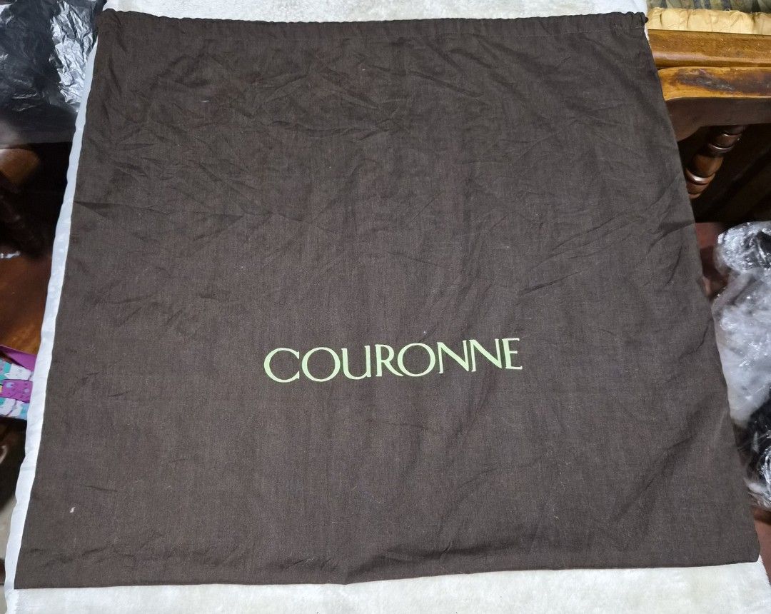 Couronne Brown Dust Bag (Category: Baby Monitors) located in Mandaue City. Submitted by chuchi152615 (Listing ID 1462791423, Image 1). Description: Brown dust bag from Couronne. Has the brand name printed in light green. Measures approximately 20 inches by 20 inches. Good for storing handbags or other accessories. Keep your items protected..
