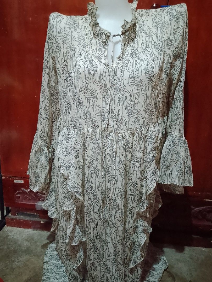 Cream and Black Wheat Pattern Ruffle Dress (Category: Dresses) located in Batangas. Submitted by sheenx.09 (Listing ID 1462724195, Image 1). Description: - L to XL - Elegant cream dress with a unique black wheat-like pattern. 😉 - Features a charming ruffled neckline with a tie detail. 😊 - Long sleeves finished with stylish ruffled cuffs. - Cascading tiered ruffles add a touch of flair down the front. 😚 - Comfortable elasticated waist for a fla