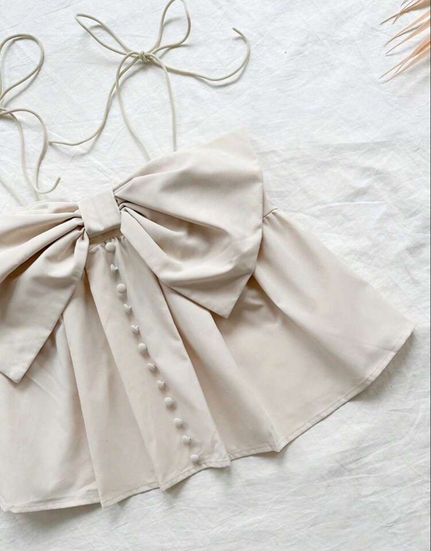 SHEIN ribbon top (khaki) (Category: Sleeveless) located in Quezon City. Submitted by jeydeegmr (Listing ID 1462706225, Image 2). Description: - Cute cream crop top - Features a big bow detail at the front - Adjustable tie straps - Smocked back for a comfy.