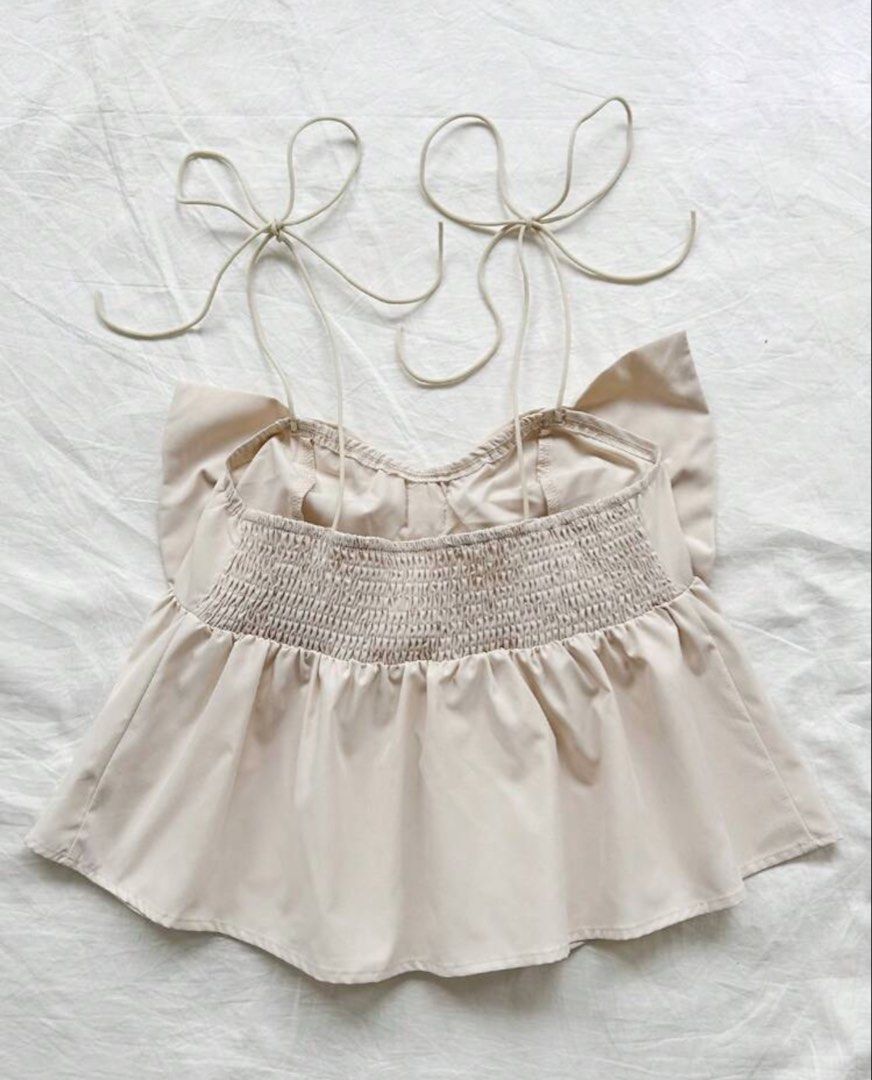 SHEIN ribbon top (khaki) (Category: Sleeveless) located in Quezon City. Submitted by jeydeegmr (Listing ID 1462706225, Image 3). Description: - Cute cream crop top - Features a big bow detail at the front - Adjustable tie straps - Smocked back for a comfy.