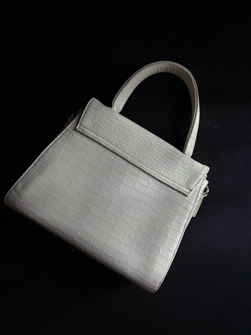Cream Croc Embossed Top Handle Bag with Strap (Category: Luxury Bags & Wallets) located in Calamba. Submitted by leeadriannn796 (Listing ID 1462710368, Image 1). Description: - Chic cream-colored handbag - Luxurious croc-embossed texture - Versatile top handle and detachable shoulder strap - Secure flap closure with hidden magnetic snap - Practical interior with black fabric lining and a zippered pocket - Ideal for both daily wear and special eve
