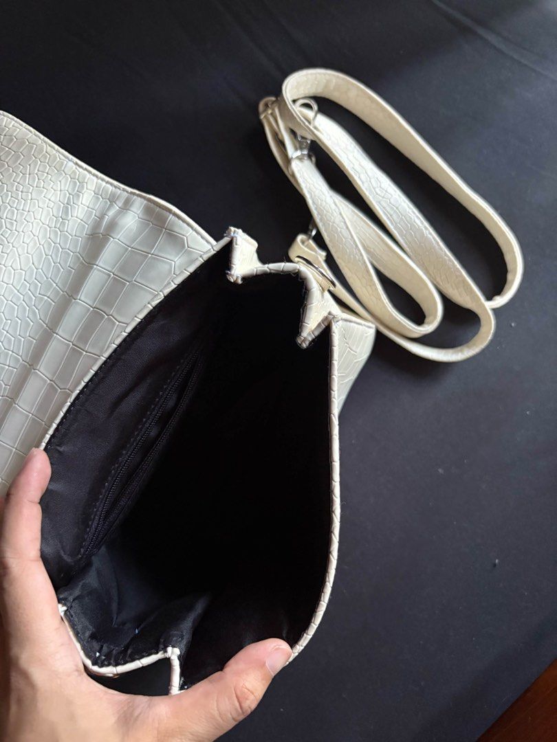 Cream Croc Embossed Top Handle Bag with Strap (Category: Luxury Bags & Wallets) located in Calamba. Submitted by leeadriannn796 (Listing ID 1462710368, Image 3). Description: - Chic cream-colored handbag - Luxurious croc-embossed texture - Versatile top handle and detachable shoulder strap - Secure flap closure with hidden magnetic snap - Practical interior with black fabric lining and a zippered pocket - Ideal for both daily wear and special eve