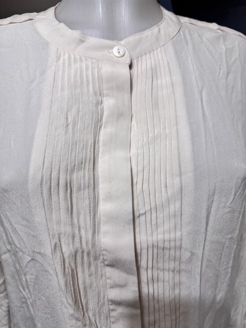 Cream Pleated Long Sleeve Button Up Blouse (Category: Dresses) located in Marikina City. Submitted by lorradel (Listing ID 1462718264, Image 3). Description: - XL on tag but fits L - Cream colored long sleeve blouse - Features subtle pleats down the front - Button up closure - Slight ruffle detail on the hem - Lightweight fabric, ideal for layering or wearing on its own - MAY HAVE some washable stains (hindi maiiwasan) needs washing; had been sto
