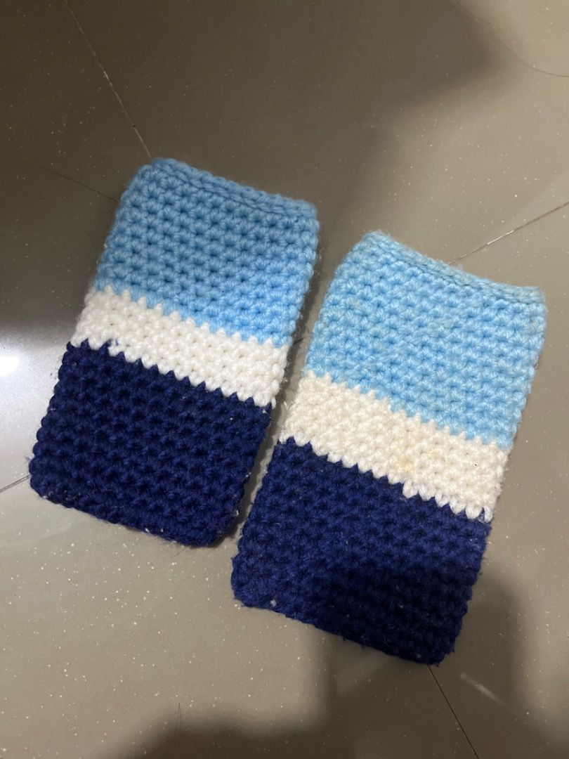 Crochet phone case (Category: Handmade Craft) located in Santiago. Submitted by evrythngulove (Listing ID 1462713505, Image 1). Description: - Handmade crocheted sleeves - Color block design: light blue, white, and navy blue stripes - Keeps arms or legs warm - Can be used as leg warmers or arm warmers - Cozy and unique accessory.
