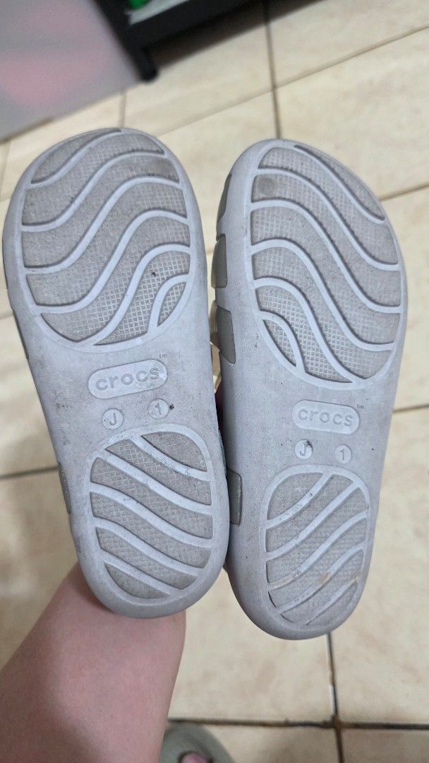 Crocs Glitter Jelly Sandals (Category: Babies & Kids Fashion) located in Manila. Submitted by joyceannelynne (Listing ID 1462825533, Image 2). Description: - Cute Crocs glitter jelly sandals - Translucent greyish color - Strappy fisherman style - Velcro strap closure for easy on/off - Ideal for beach or casual outings - Easy to clean material - Visible Crocs logo on strap.