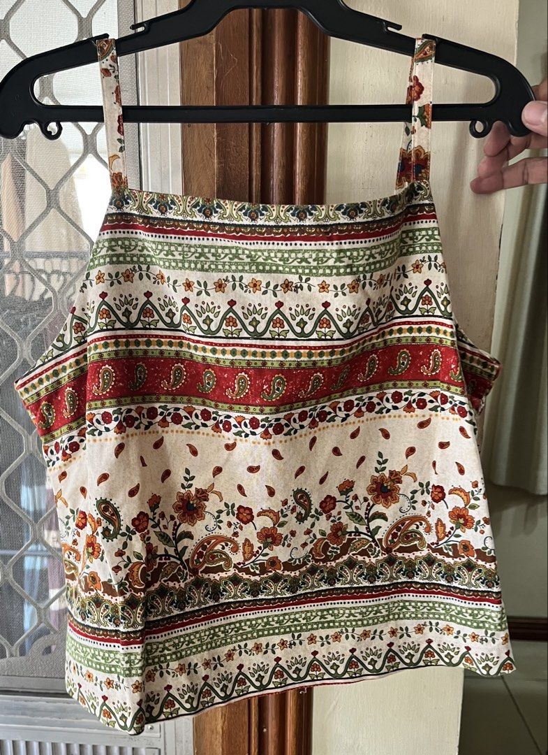 Crop top (Category: Blouses) located in Bacoor. Submitted by ayit. (Listing ID 1462718137, Image 2). Description: - Trendy crop top with a vibrant bohemian print - Features floral and paisley patterns in red, green, and orange - Size: Small (S) - Perfect for casual outings and summer vibes - Condition: Excellent.