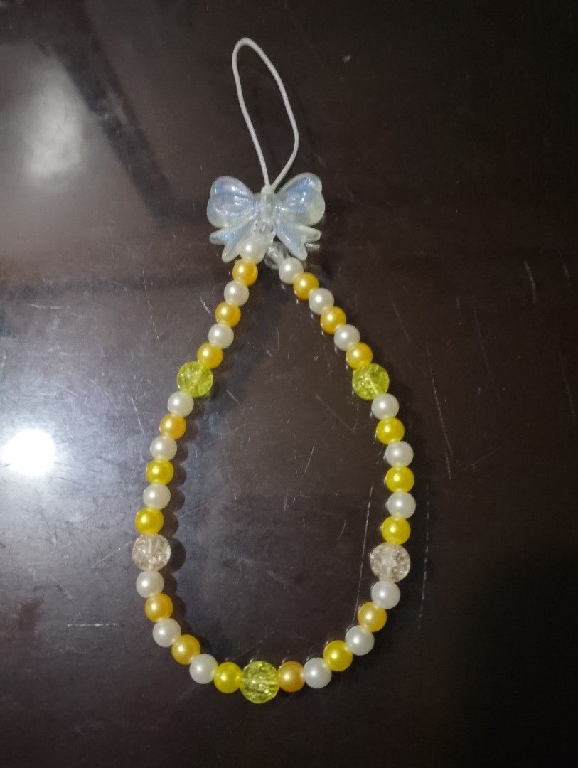Cute Beaded Charm with Bow (Category: Charms) located in San Jose del Monte. Submitted by pinkpenguin.2005ya (Listing ID 1462824080, Image 1). Description: - Handmade beaded charm - Features white, yellow, and sparkly clear beads - Adorned with a cute white bow at the top - Ideal for decorating bags or keys - A unique accessory to personalize your items.