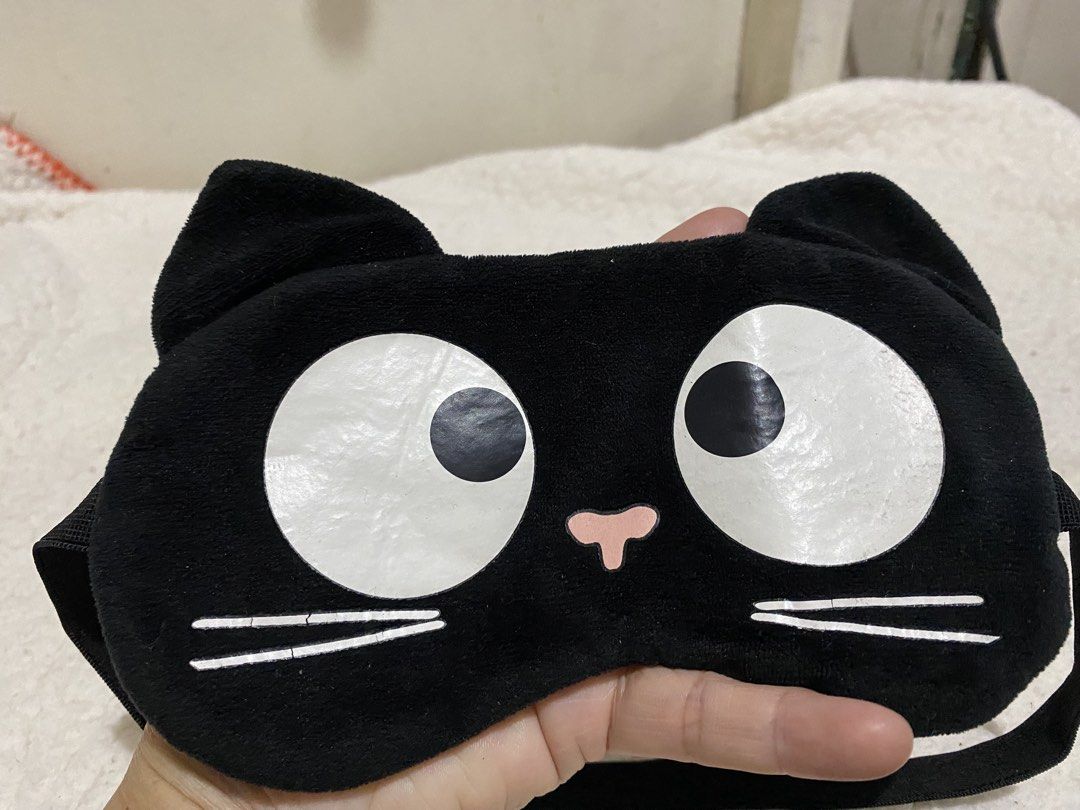 Cute Black Cat Plush Eye Mask for Sleep (Category: Sunglasses & Eyewear) located in Manila. Submitted by resi.diaz (Listing ID 1462874193, Image 2). Description: - Adorable black plush eye mask with a cute cat face design. - Features charming big white eyes and little ears. - Equipped with an elastic strap for a secure and comfortable fit. - Ideal for blocking out light for better sleep or during travel. - Made with soft material for ultimate com