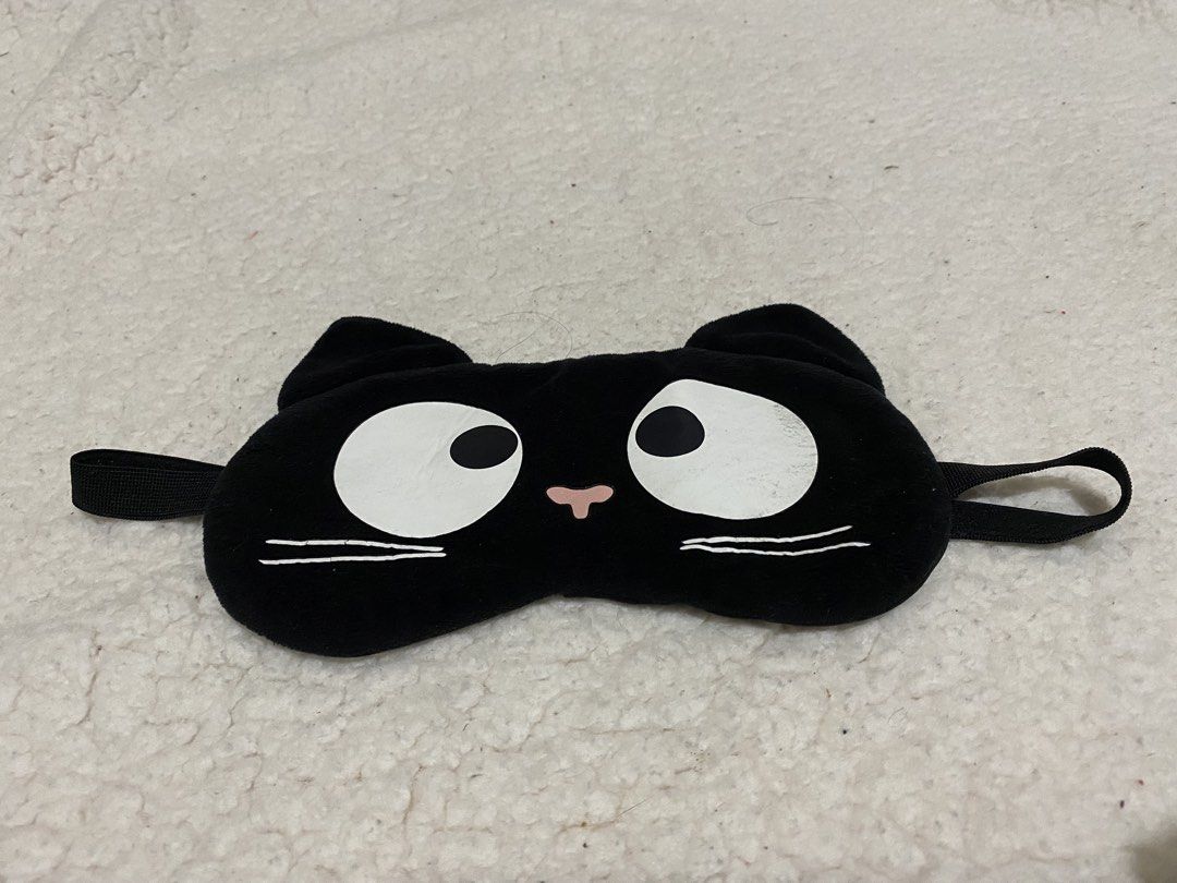 Cute Black Cat Plush Eye Mask for Sleep (Category: Sunglasses & Eyewear) located in Manila. Submitted by resi.diaz (Listing ID 1462874193, Image 1). Description: - Adorable black plush eye mask with a cute cat face design. - Features charming big white eyes and little ears. - Equipped with an elastic strap for a secure and comfortable fit. - Ideal for blocking out light for better sleep or during travel. - Made with soft material for ultimate com
