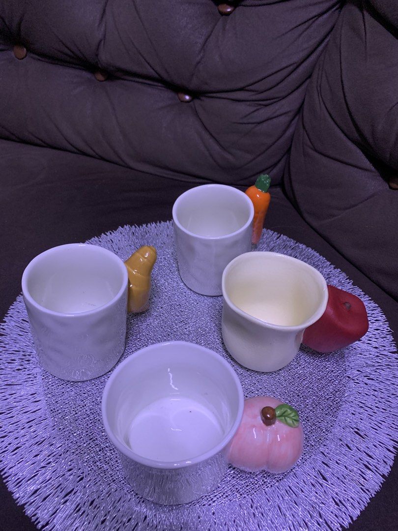 Cute Ceramic Mugs with Fruit and Pastry Handles (Category: Coffee & Tea Tableware) located in Cavite. Submitted by thinkerbelle_certified (Listing ID 1462718531, Image 3). Description: - Set of 4 ceramic mugs - Each mug features a unique handle shaped like a fruit or pastry - Includes: peach, apple, croissant, and carrot designs - White mugs with colorful, playful handles - Ideal for coffee, tea, or hot chocolate - Adds a fun, decorative touch to