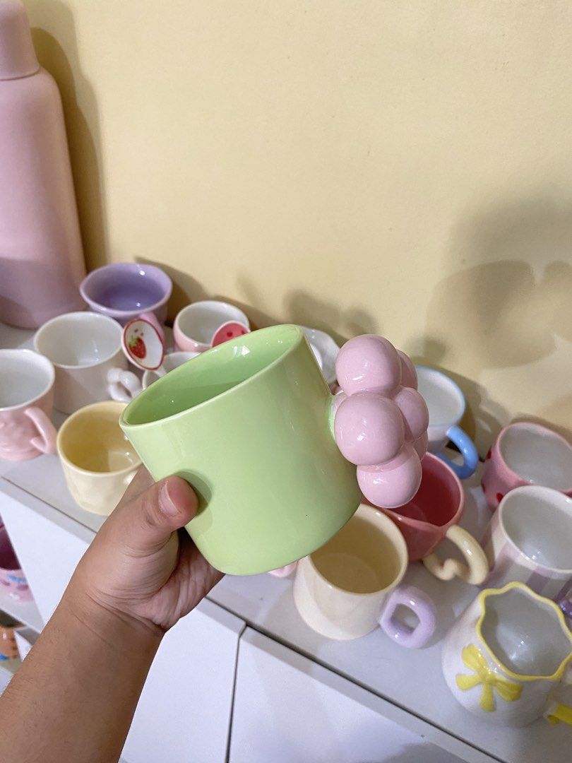 CUTE GREEN MUG WITH FLOWER HANDLE (Category: Coffee & Tea Tableware) located in Dasmarinas. Submitted by hannah.oakph (Listing ID 1462774143, Image 2). Description: paint issue only sa handle banda.