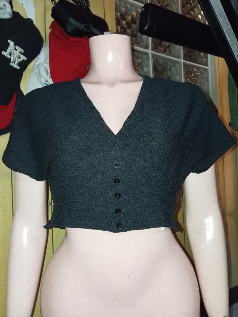 Dark Grey V-Neck Button-Up Cropped Knit Top (Category: Blouses) located in Cebu City. Submitted by smnthdanielle (Listing ID 1462882592, Image 2). Description: - Dark grey cropped knit top - V-neckline - Button-up front - Short, fluttery sleeves - Lettuce hem detail - Comfortable and stylish - Pairs well with high-waisted bottoms.