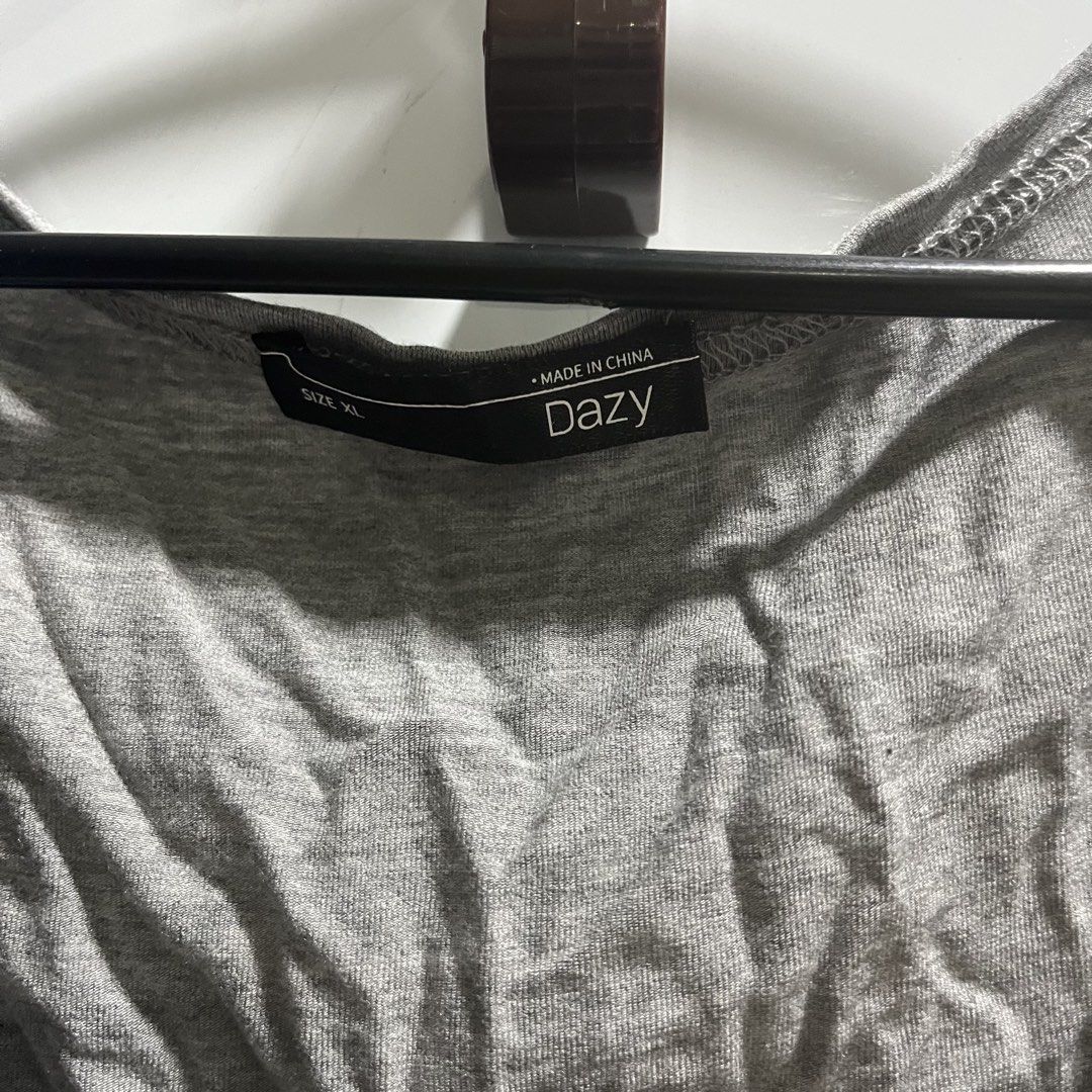 Dazy Grey Square Neck Tie Front Crop Top (Category: Blouses) located in Manila. Submitted by 4ngeluh (Listing ID 1462684176, Image 2). Description: - Grey crop top from Dazy - Features a square neckline with a tie front detail - Short sleeves - Versatile for styling with jeans or skirts - Ideal for casual wear.