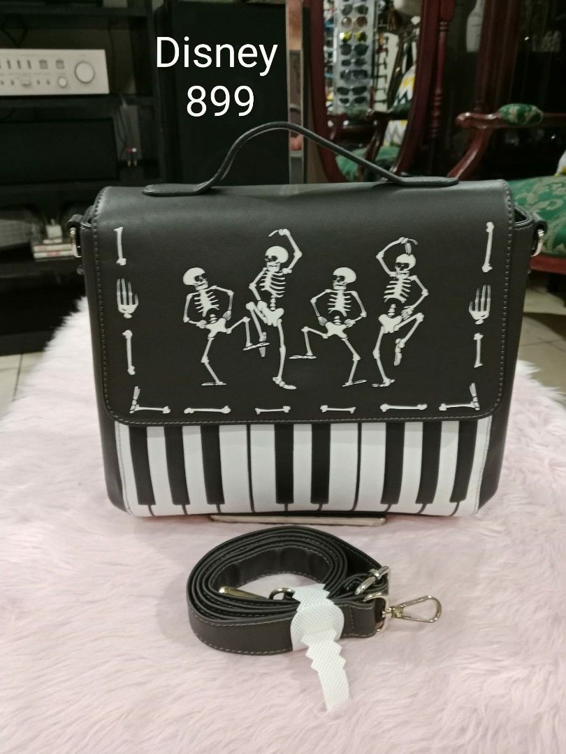 Disney Skeleton Piano Crossbody Bag (Category: Cross-body Bags) located in Pasig City. Submitted by janalopez904 (Listing ID 1462863996, Image 1). Description: -Glow in the dark - Unique Disney bag featuring a skeleton and piano design. - Classic black with stylish white accents. - Comes with a comfortable top handle. - Includes a detachable crossbody strap for versatile carrying. - Ideal for Halloween or adding a touch of fun to any outfit. - St