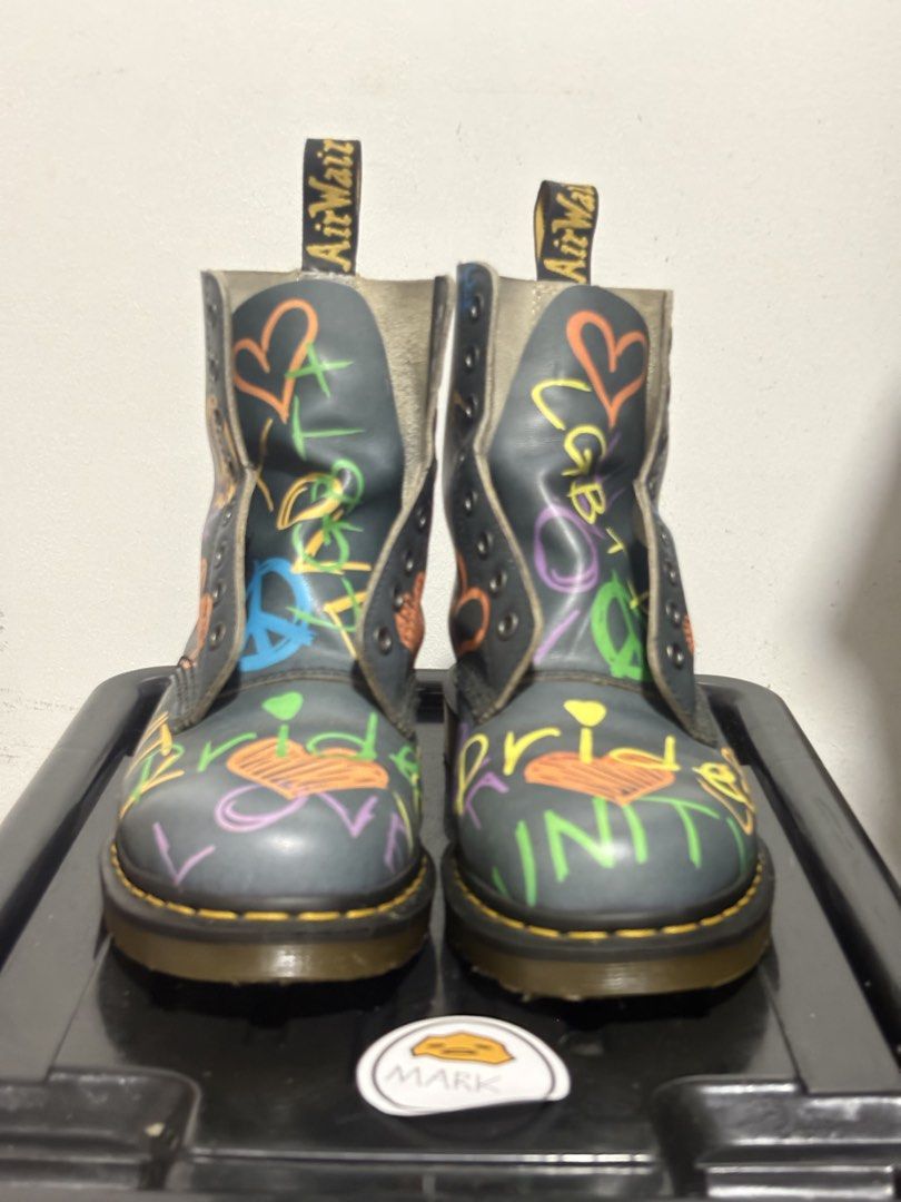 Dr. Martens 1460 Pride Boots Graffiti (Category: Boots) located in Cebu City. Submitted by xoxoxo888marco (Listing ID 1462834518, Image 1). Description: - Dr. Martens 1460 boots - Unique rainbow graffiti design - Features 'Pride', 'Love', 'Peace', 'Unity', 'LGBT+' text - Adorned with hearts and peace signs - Classic yellow stitching - Durable AirWair sole - Eye-catching and bold style statement Uk 7 US 8m .