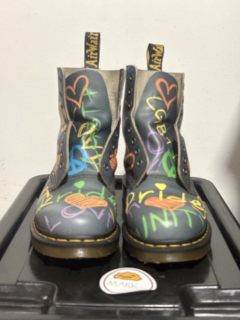 Dr. Martens 1460 Pride Boots Graffiti (Category: Boots) located in Cebu City. Submitted by xoxoxo888marco (Listing ID 1462834518, Image 2). Description: - Dr. Martens 1460 boots - Unique rainbow graffiti design - Features 'Pride', 'Love', 'Peace', 'Unity', 'LGBT+' text - Adorned with hearts and peace signs - Classic yellow stitching - Durable AirWair sole - Eye-catching and bold style statement Uk 7 US 8m .