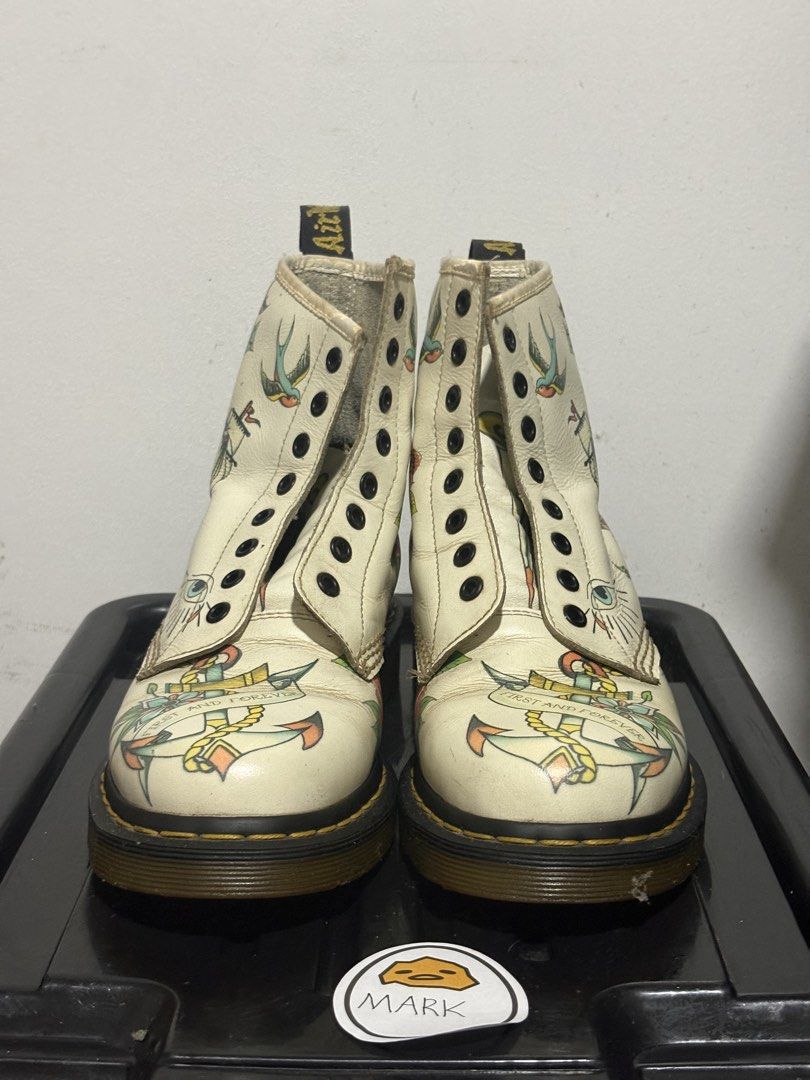Dr. Martens 1460 Tattoo Art Boots (Category: Boots) located in Cebu City. Submitted by xoxoxo888marco (Listing ID 1462834655, Image 3). Description: - Authentic white Dr. Martens 1460 boots - Unique traditional tattoo art designs: skulls, roses, swallows, nautical elements - Classic Dr. Martens air-cushioned sole for comfort and durability - Secure lace-up closure - Eye-catching statement piece to elevate any outfit Uk 7 US M8.