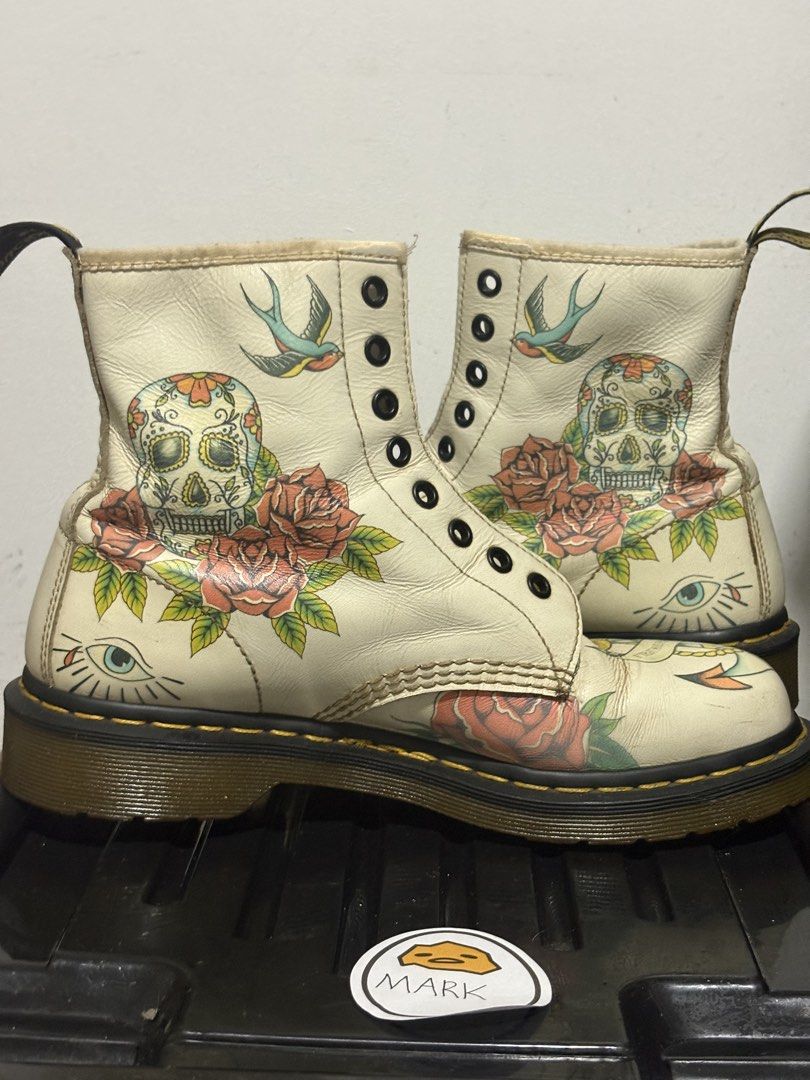 Dr. Martens 1460 Tattoo Art Boots (Category: Boots) located in Cebu City. Submitted by xoxoxo888marco (Listing ID 1462834655, Image 1). Description: - Authentic white Dr. Martens 1460 boots - Unique traditional tattoo art designs: skulls, roses, swallows, nautical elements - Classic Dr. Martens air-cushioned sole for comfort and durability - Secure lace-up closure - Eye-catching statement piece to elevate any outfit Uk 7 US M8.
