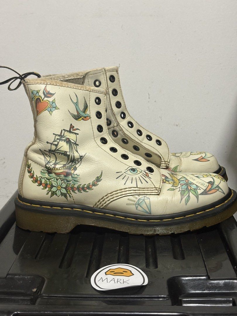 Dr. Martens 1460 Tattoo Art Boots (Category: Boots) located in Cebu City. Submitted by xoxoxo888marco (Listing ID 1462834655, Image 2). Description: - Authentic white Dr. Martens 1460 boots - Unique traditional tattoo art designs: skulls, roses, swallows, nautical elements - Classic Dr. Martens air-cushioned sole for comfort and durability - Secure lace-up closure - Eye-catching statement piece to elevate any outfit Uk 7 US M8.