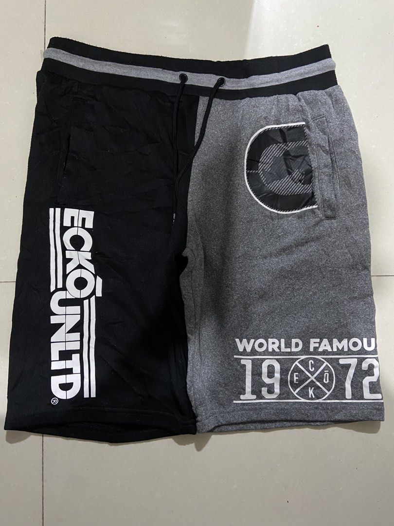 Ecko Unltd. Split Color Sweat Shorts XL (Category: Shorts) located in Cavite. Submitted by hail1530 (Listing ID 1462831798, Image 1). Description: - Ecko Unltd. shorts in XL size. - Stylish black and grey split design. - Features Ecko Unltd. logo on black side. - 'World Famous 1972' graphic on grey side. - Comfortable elastic waistband with drawstring. - Two convenient side pockets. - Ideal for everyday casual wear..