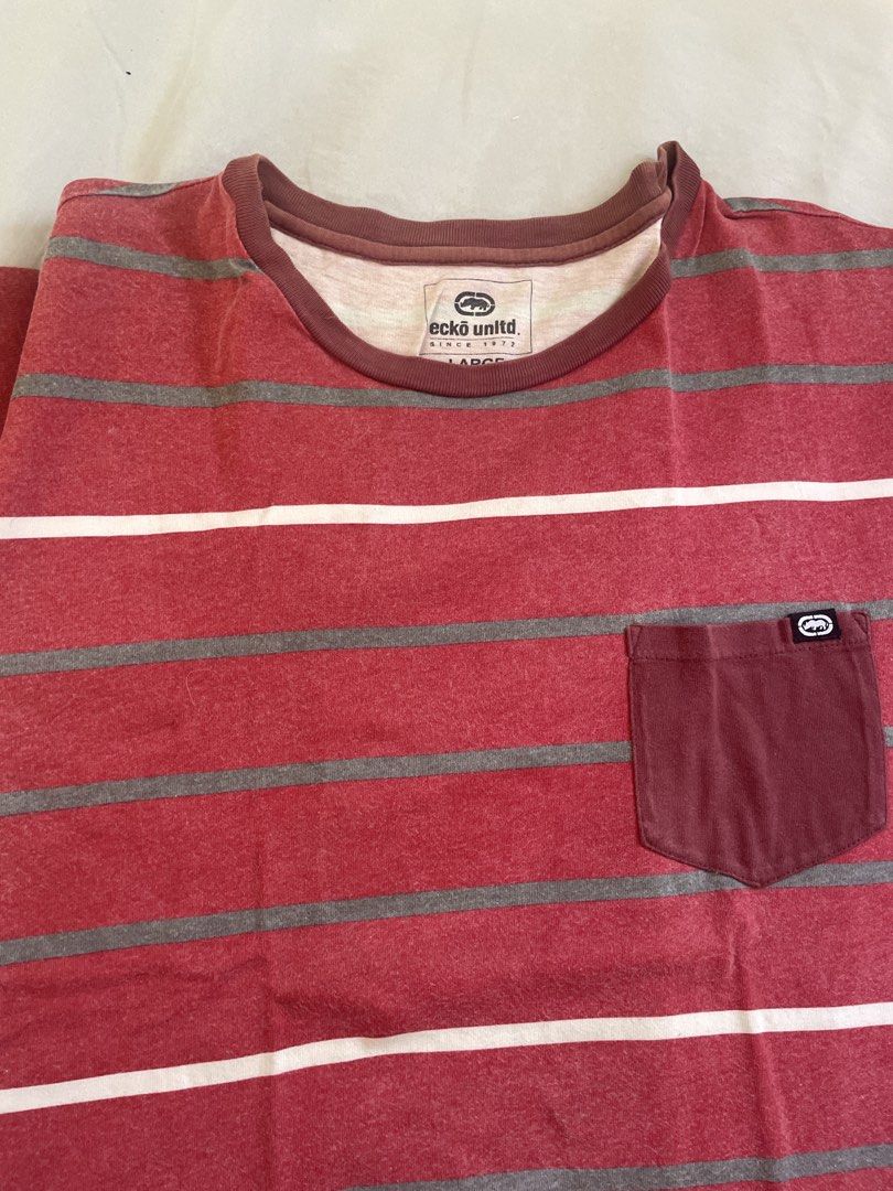 Ecko Unltd. Striped Pocket T-Shirt (Category: Tshirts & Polo Shirts ) located in Cavite. Submitted by yvetteroyce (Listing ID 1462683851, Image 2). Description: - Brand: Ecko Unltd. - Color: Red and Grey Stripes - Size: Large - Features: Chest pocket with Ecko logo - Style: Casual wear.