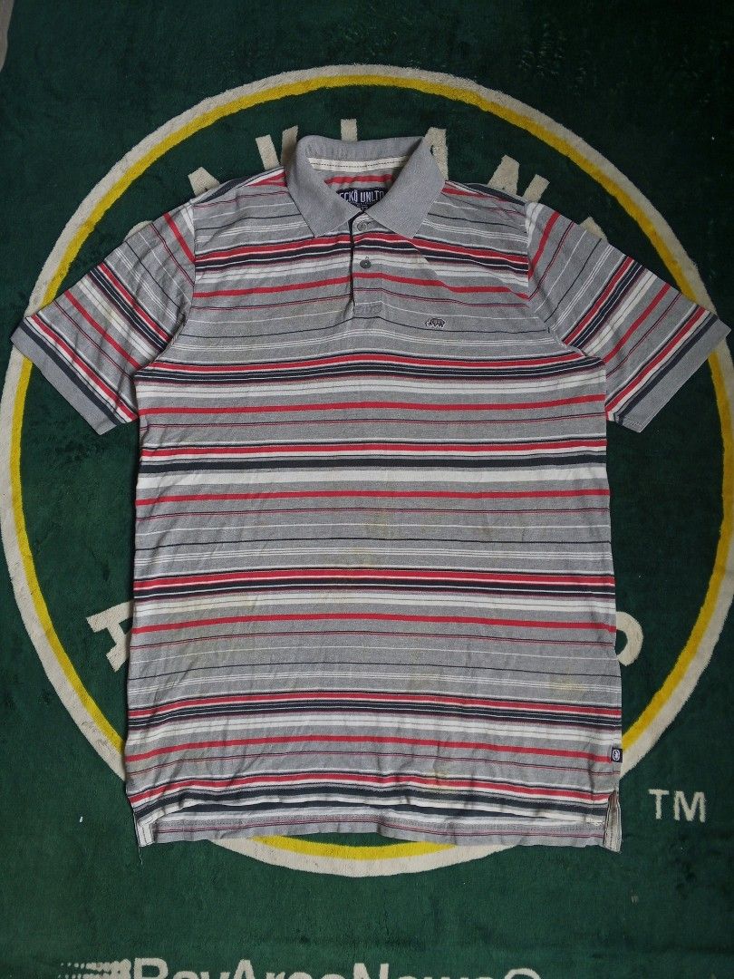 Ecko Unltd. Striped Polo Shirt Size L (Category: Tshirts & Polo Shirts ) located in Las Pinas. Submitted by allhandpick (Listing ID 1462865484, Image 1). Description: - Brand: Ecko Unltd. - Color: Grey with red, white, and navy stripes - Material: 100% Cotton - Tag detail: 'Actual 1972 Factual' - Style: Casual wear.