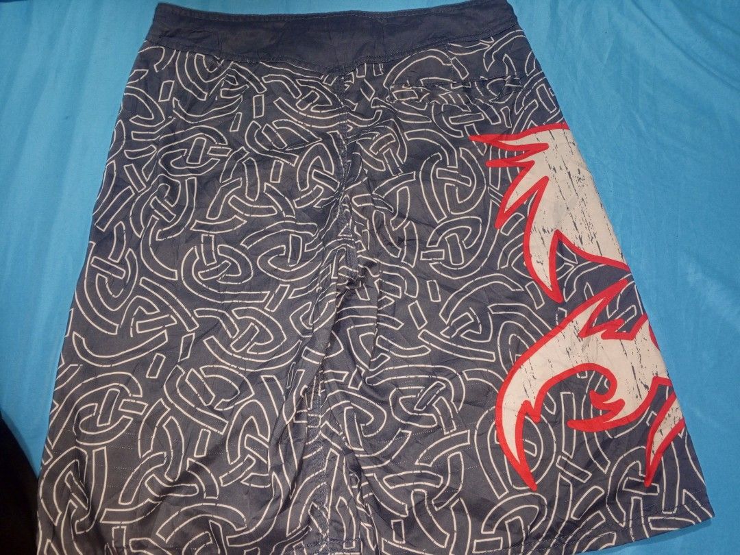 Elite MMA Fight Shorts Size Medium (Category: Shorts) located in Baguio. Submitted by musashinz (Listing ID 1462820645, Image 2). Description: - Elite MMA fight shorts - Size: Medium - Color: Dark grey - Design: White and red Celtic knot pattern - Graphics: Large white and red wolf graphic (left leg), Elite MMA logo (right leg) - Ideal for: Training or casual wear.