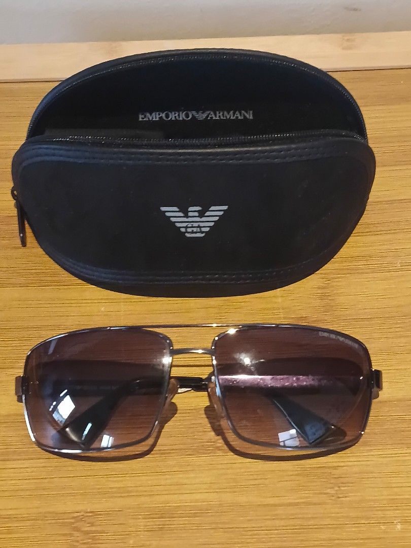 Emporio Armani Sunglasses with Case (Category: Sunglasses & Eyewear) located in Binan City. Submitted by jrmangge (Listing ID 1462780186, Image 1). Description: - Authentic Emporio Armani sunglasses - Includes original black hard case with Emporio Armani logo - Features brown tinted lenses - Ideal for sunny weather protection - Case ensures safe storage.