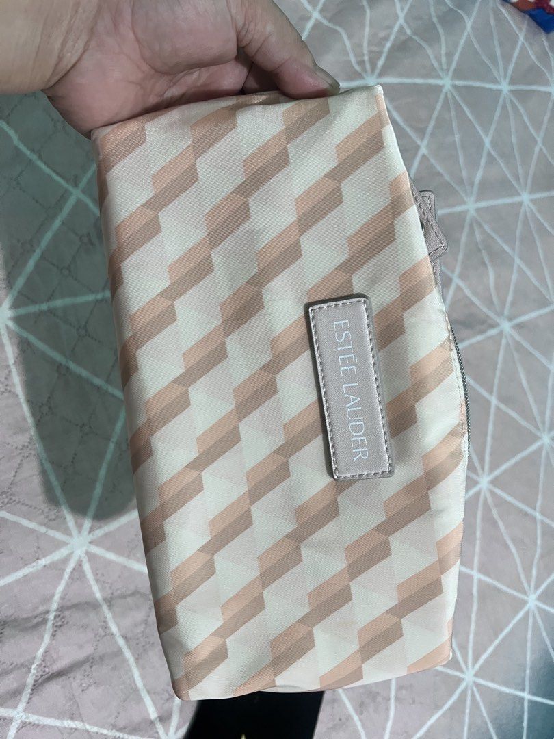 Estee Lauder Cosmetic Bag Pouch (Category: Purses & Pouches) located in Manila. Submitted by cleverstone_21f597 (Listing ID 1462708643, Image 1). Description: - Stylish Estee Lauder pouch with a unique geometric pattern. - Made from eco-friendly recycled materials. - Secure zip closure to keep your items safe. - Features a convenient small handle for easy carrying. - Ideal for organizing makeup, toiletries, or travel essentials. - Easy to clean a