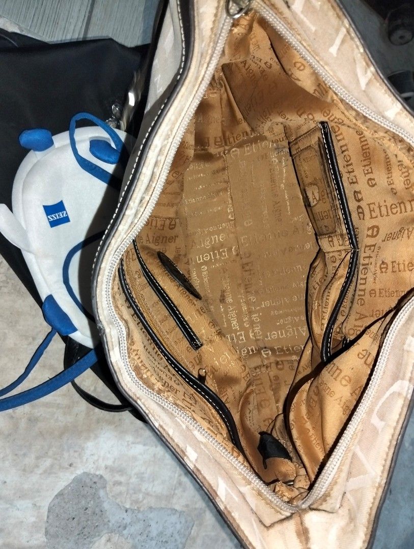 Etienne Aigner Hobo Shoulder Bag (Category: Shoulder Bags) located in Caloocan City. Submitted by girlshopmcollection (Listing ID 1462832582, Image 2). Description: - Authentic Etienne Aigner shoulder bag - Color: Beige canvas with brown leather trim - Design: All-over signature monogram print - Interior: Includes zippered pockets for organization - Interior Lining: Some wear present - Hardware: Exhibits rust and wear - Please review all photos c