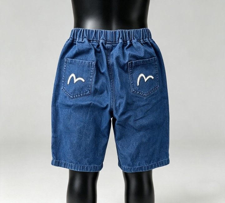 EVISU Denim Shorts with Graphic Print (Category: Babies & Kids Fashion) located in Baguio. Submitted by miishaysh67446 (Listing ID 1461661693, Image 2). Description: - Blue denim shorts - Comfortable elastic waistband - Cool graphic print on front pocket - Signature Evisu logo on back pockets - Ideal for casual wear no tags.