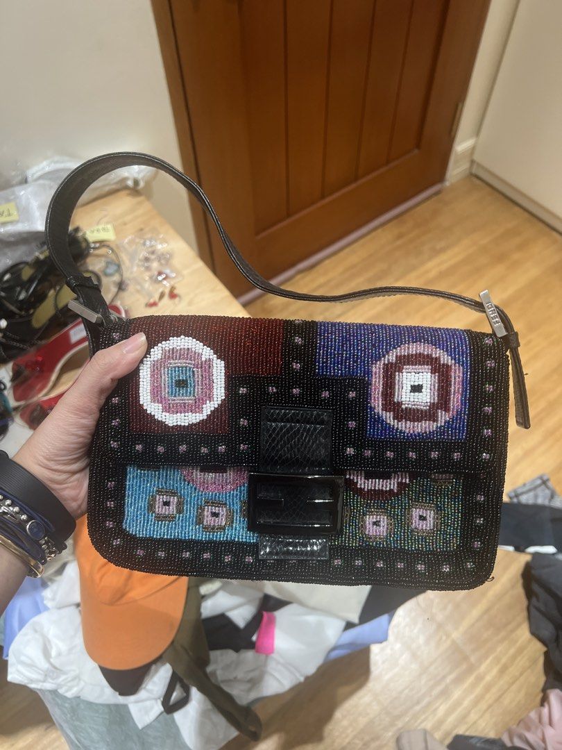 Fendi Beaded Baguette Bag (NGA) (Category: Luxury Bags & Wallets) located in Quezon City. Submitted by iminquezoncity (Listing ID 1462683263, Image 1). Description: - Fendi Baguette Bag - Intricate beadwork with colorful geometric patterns on front - Unique beaded design on back - Black leather strap and trim - Silver Fendi hardware - Magnetic snap closure - Perfect statement piece for your collection.