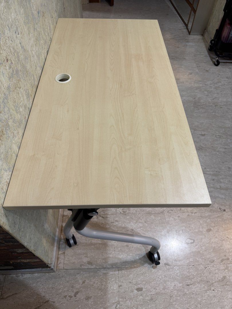 Foldable Table with Wheels (Category: Tables & Sets) located in Singapore. Submitted by shirleyjia38253 (Listing ID 1462829641, Image 3). Description: Long 120cm*Wide 60cm*High 75cm - Light wood tabletop - Sturdy black and silver frame - Built-in wheels for easy mobility - Foldable design for convenient storage - Integrated cable management hole - Ideal for small spaces and temporary setups - Functional and durable.