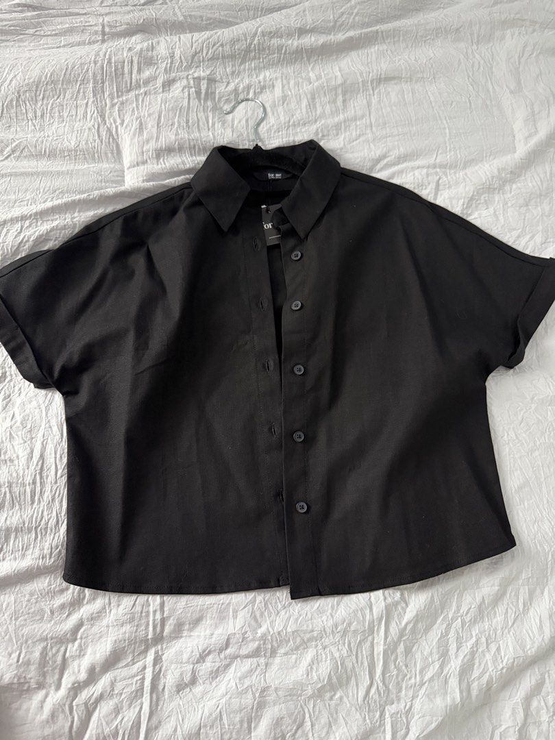 FOR ME Black Cropped Button-Up Shirt (Category: Shirts) located in Bacoor. Submitted by annmaliksi (Listing ID 1462757340, Image 1). Description: - FOR ME black cropped shirt - Short sleeves with rolled cuffs - Classic collar and button-up front - Relaxed fit - Versatile for layering or wearing on its own - Easy to style with any outfit Brandnew with tag.
