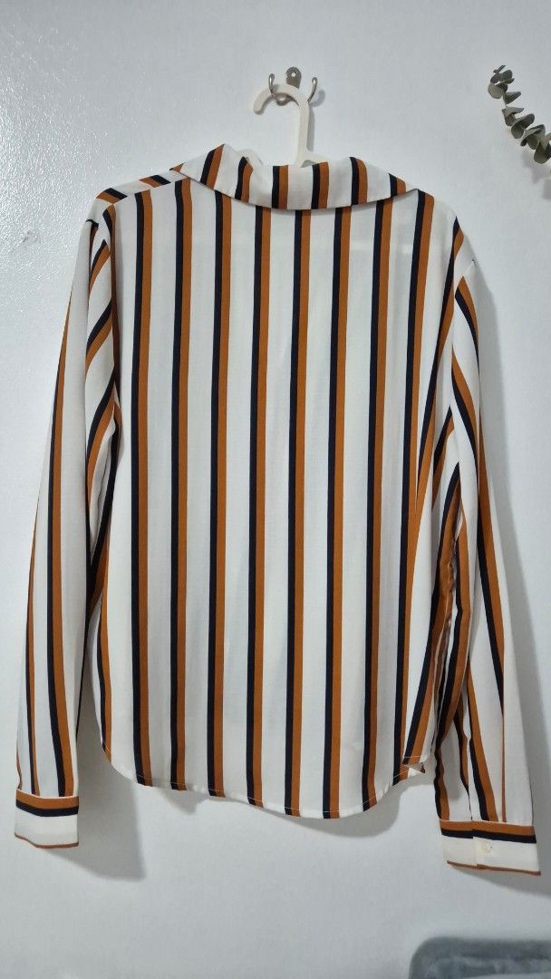 Forever 21 Striped Long Sleeve Shirt (Category: Longsleeves) located in Pasig City. Submitted by magnoliafern (Listing ID 1462816101, Image 3). Description: - Forever 21 long sleeve shirt - Classic stripe pattern: white, navy, and rust - Button-up front - Chest pocket - Material: 100% polyester - Ideal for casual outfits or layering.