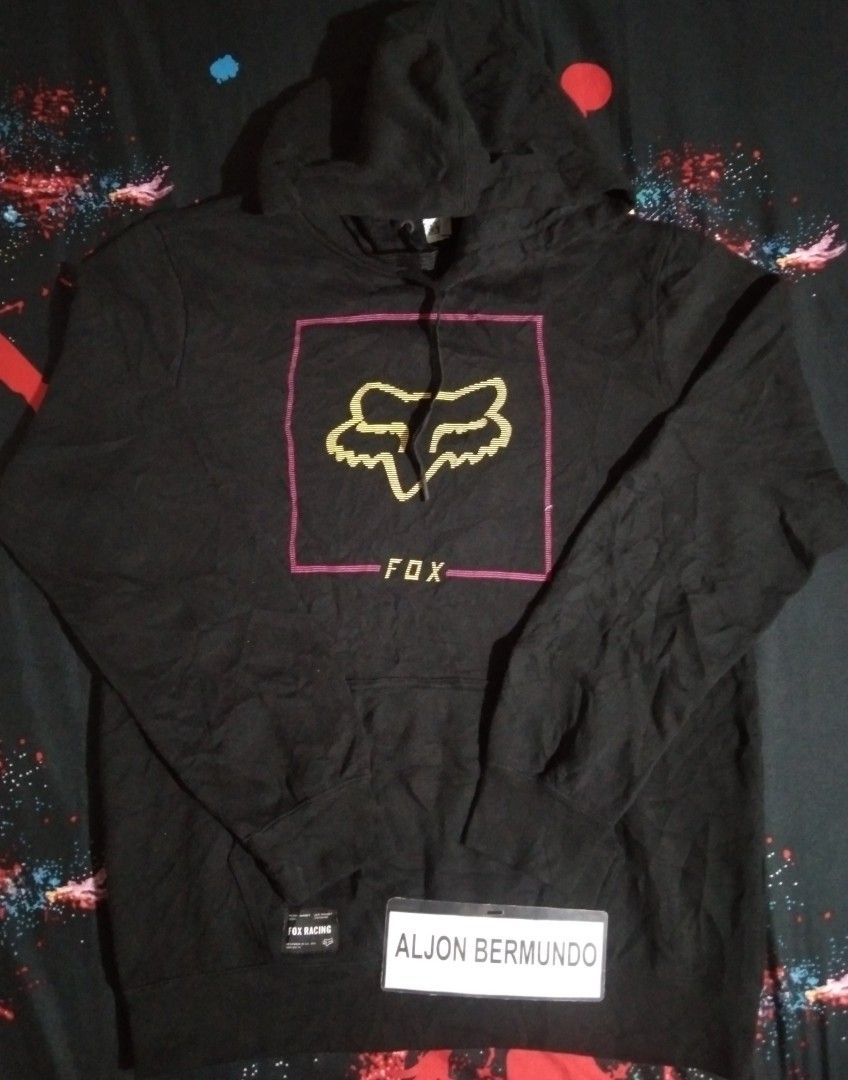Fox Racing Black Hoodie (Category: Hoodies) located in Quezon City. Submitted by aljonbermu25659 (Listing ID 1462713273, Image 1). Description: - Black Fox Racing Hoodie - Size: Medium (MD) - Iconic Fox head logo with pink and gold outline - Designed in California, Made in China - Ideal for casual wear.