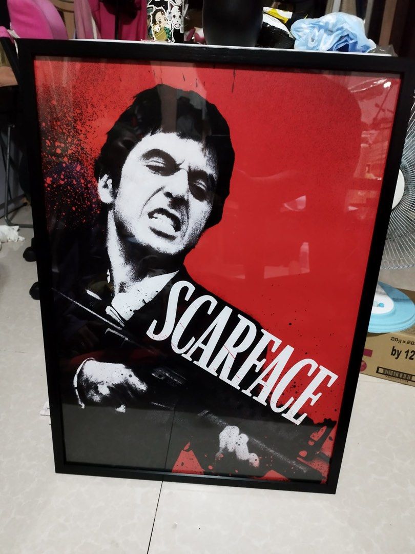Framed Scarface Movie Poster (Category: Art & Prints) located in Bacoor. Submitted by dangeusebio1515 (Listing ID 1462780210, Image 1). Description: - Framed poster of the iconic Scarface movie. 19x27 inches with frame - Features Al Pacino as the legendary Tony Montana. - Striking design with a red background and black and white graphic. - Perfect for any movie enthusiast's room. - Comes ready to hang for easy display..