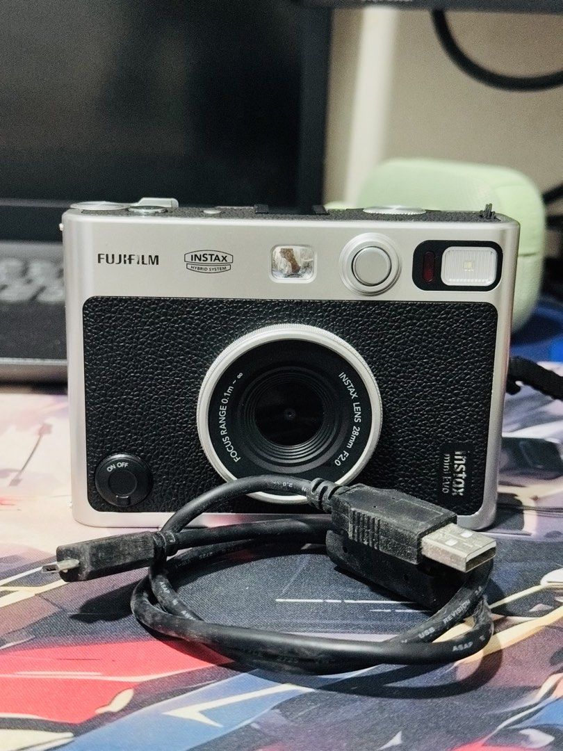 Fujifilm Instax Mini Evo Hybrid Instant Camera (Category: Cameras) located in Manila. Submitted by declutteross (Listing ID 1462875811, Image 2). Description: - Fujifilm Instax Mini Evo hybrid instant camera - Color: Black - Includes original strap - Comes with original USB charging cable - Ideal for both instant photos and digital prints - User-friendly controls on the back - Ready for your next event! - No issues or history of repair ‼️PRICE ST