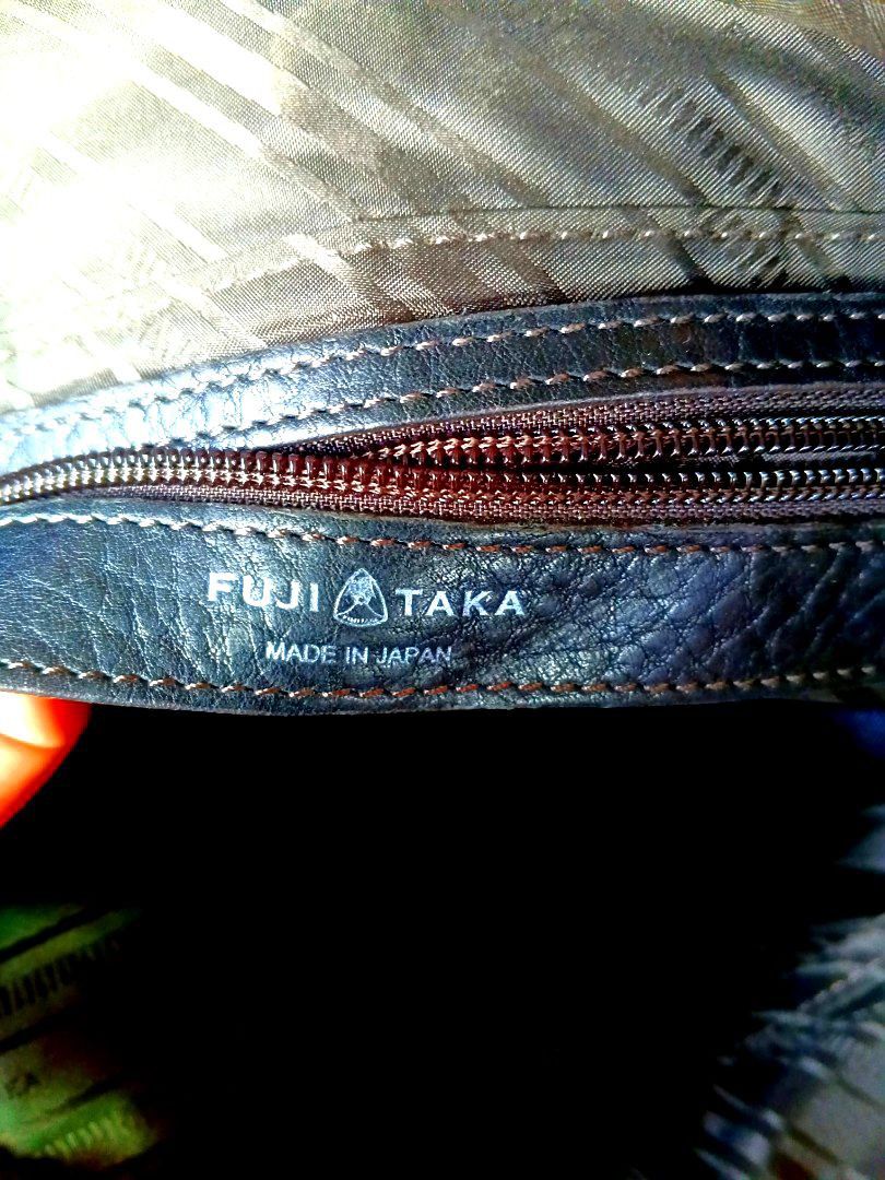 FUJITAKA GENUINE LEATHER AND VINTAGE (Category: Briefcases) located in Manila. Submitted by icamalicdem29 (Listing ID 1462492068, Image 2). Description: - Sleek black leather briefcase - Elegant brown leather accents on handles and strap attachments - Multiple interior compartments for organized storage - Includes a detachable shoulder strap for versatile carrying - Approximately 16 inches wide Fujitaka leather briefcase or business bag. Fujitaka