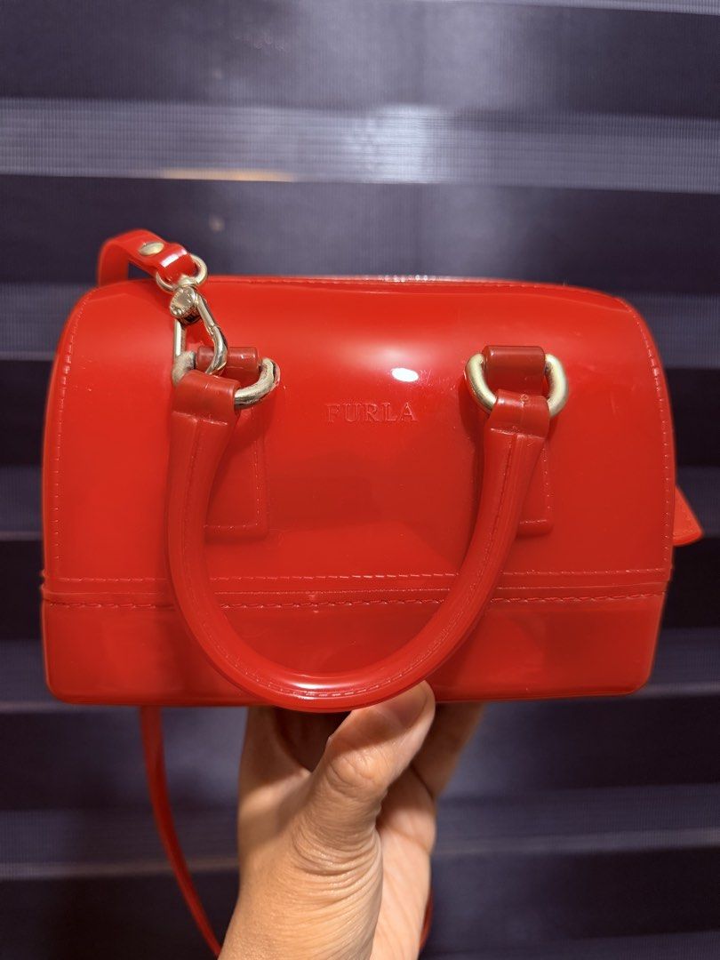 Furla Candy Mini Boston Bag Red Jelly (Category: Luxury Bags & Wallets) located in Tarlac. Submitted by rizasdeclutteringonline (Listing ID 1462857207, Image 2). Description: - Adorable red Furla mini Boston bag - Made from durable jelly material - Comes with comfortable top handles - Includes a detachable shoulder strap for versatile carrying - Secure zipper closure - Compact size, ideal for carrying your essentials - Authentically Made in Italy