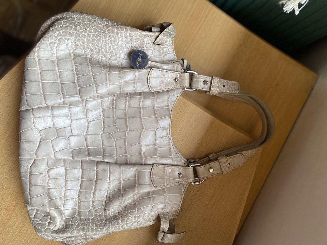 Furla Crocodile Embossed Leather Shoulder Bag (Category: Luxury Bags & Wallets) located in Batangas. Submitted by lux_kimmy (Listing ID 1462704974, Image 3). Description: - Light beige Furla shoulder bag - Crocodile embossed leather texture - Silver hardware details - Adjustable shoulder straps - Classic everyday bag with plenty of space - Ideal for work or casual outings - Shows some signs of wear on straps and edges Preloved Authentic Furla Bag