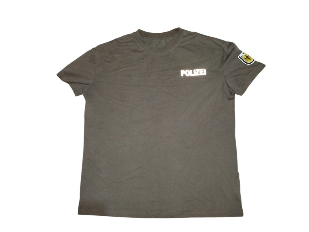 German POLIZEI T-Shirt with Emblem (Category: Tshirts & Polo Shirts ) located in Quezon City. Submitted by y2k_thriftkid (Listing ID 1462690477, Image 1). Description: - Grey t-shirt with 'POLIZEI' printed on front and back. - Features a police emblem on the left sleeve. - Standard fit for comfortable wear. - Perfect for casual outfits or costume parties..