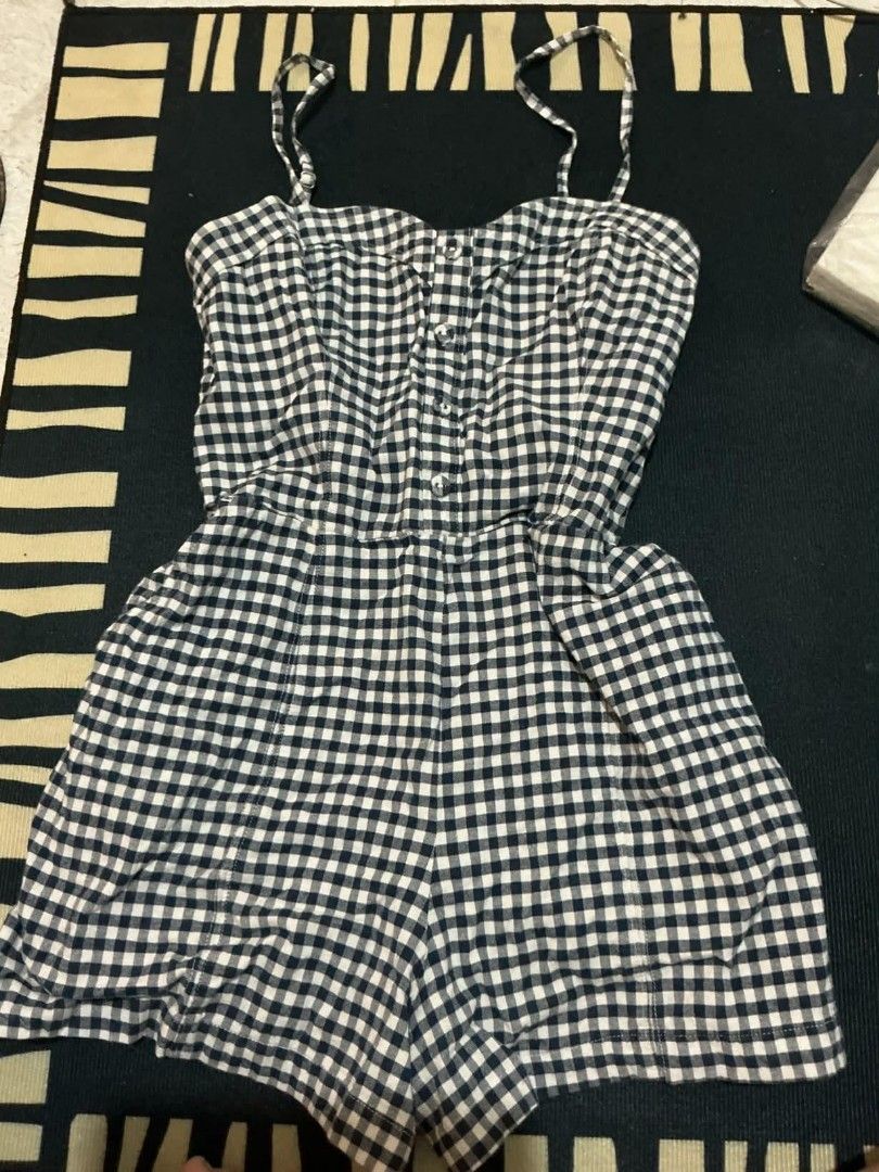 Gingham Spaghetti Strap Romper (Category: Rompers) located in Quezon City. Submitted by nicskulasa (Listing ID 1462810307, Image 1). Description: - Adorable black and white gingham romper - Features delicate spaghetti straps - Functional button-up front - Relaxed, flowy fit shorts - Ideal for casual outings or beach days - Effortless to wear and style.