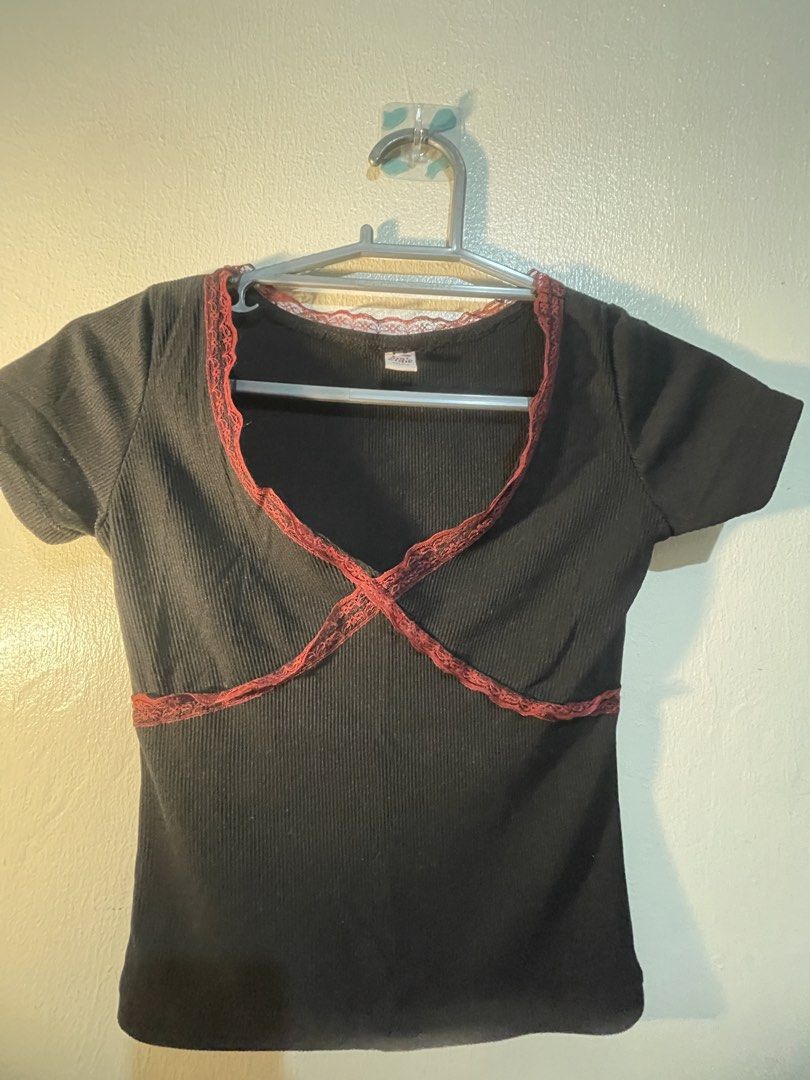 Girl Code Black Ribbed Lace Trim V-Neck Top Size Small (Category: Shirts) located in Manila. Submitted by sammmm777 (Listing ID 1462814864, Image 2). Description: - Brand: Girl Code - Color: Black - Material: Ribbed, stretchy - Neckline: V-neck - Details: Red lace trim on V-neck and crossing over bust - Sleeves: Short - Style: Versatile for casual or dressed-up looks.