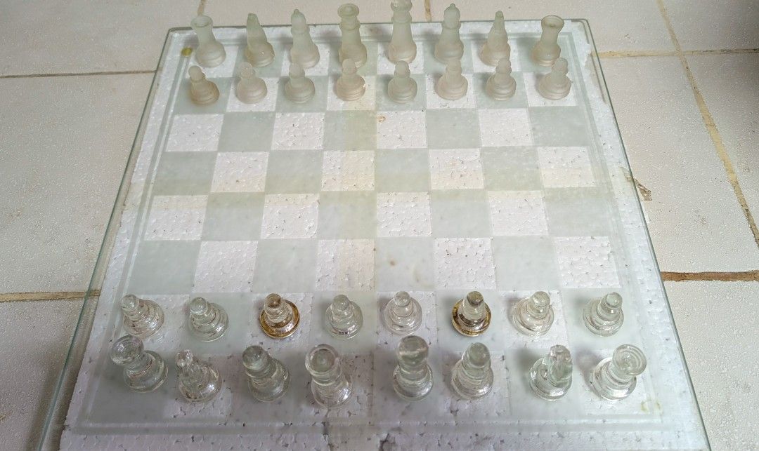 Glass Chess and Checkers (Category: Board Games & Puzzles) located in Manila. Submitted by kikopabilla (Listing ID 1462699423, Image 2). Description: A classic glass board game set, including complete pieces for both chess and checkers, is securely packaged in a box with styrofoam for protection..