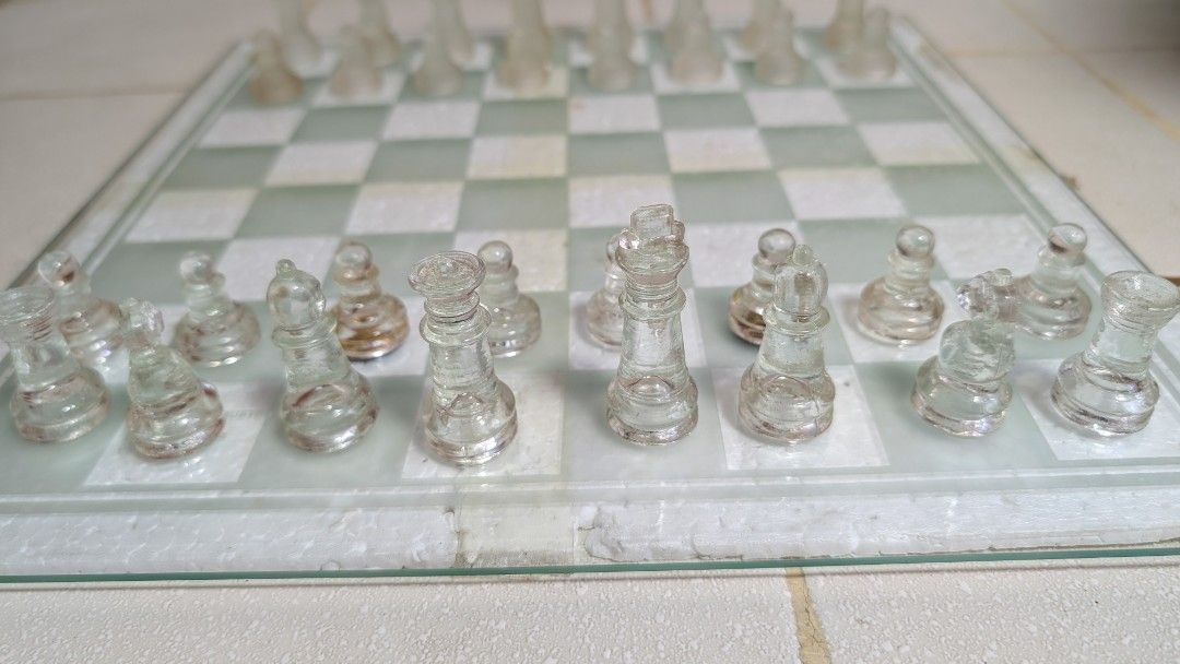 Glass Chess and Checkers (Category: Board Games & Puzzles) located in Manila. Submitted by kikopabilla (Listing ID 1462699423, Image 3). Description: A classic glass board game set, including complete pieces for both chess and checkers, is securely packaged in a box with styrofoam for protection..