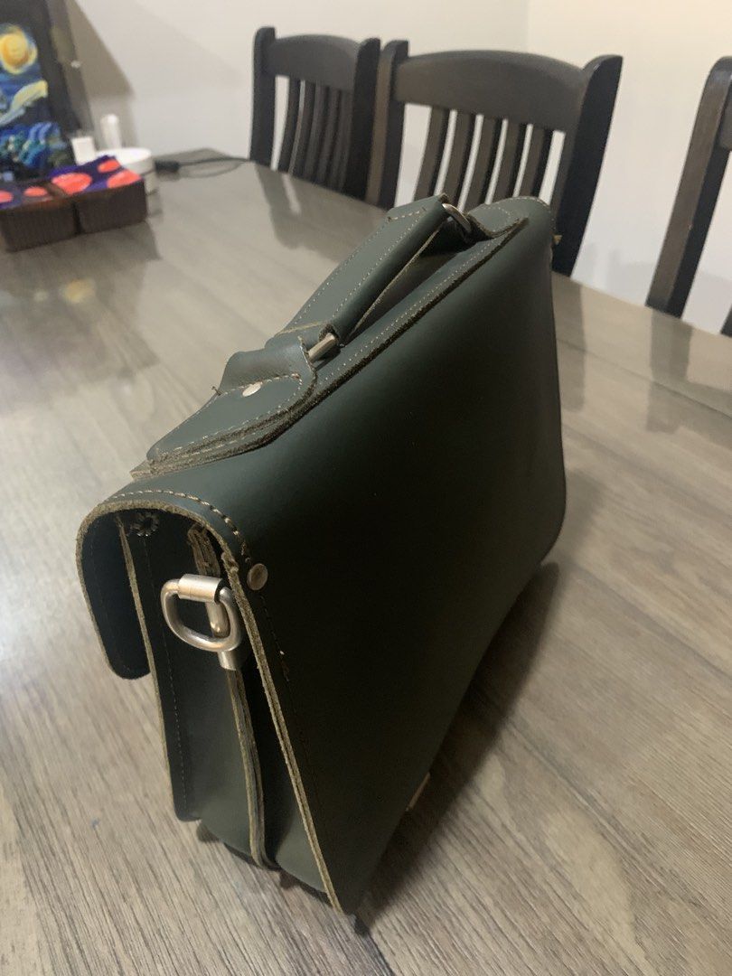 GRAFEA Leather Satchel Bag - Made in England (Category: Luxury Bags & Wallets) located in Mandaluyong City. Submitted by lgariba (Listing ID 1462718636, Image 3). Description: - Classic dark green leather satchel from GRAFEA - Handcrafted in England - Top handle and detachable shoulder strap - Multiple interior compartments - Two convenient front pockets - Secure buckle closures - Ideal for work or everyday carry.