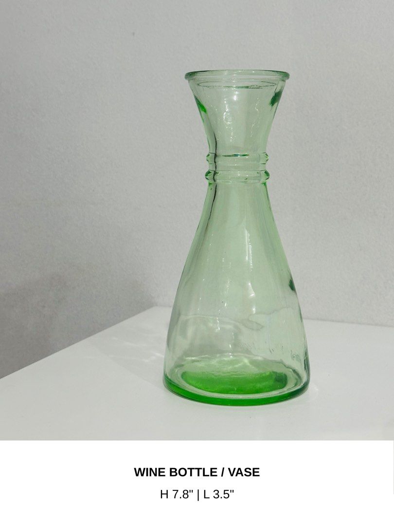 Green Glass Wine Bottle Vase (Category: Vases & Decorative Bowls) located in Manila. Submitted by anaya_d (Listing ID 1462803622, Image 1). Description: Can be used as a wine bottle, for flowers, or as a decorative piece. Adds a pop of color to any space 🍀.