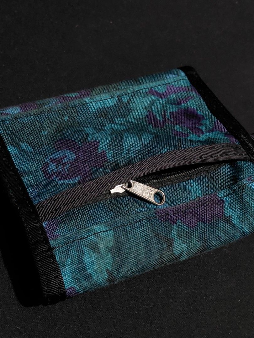 Gregory Tri-Fold Wallet Floral Pattern (Category: Wallets & Card holders) located in Pozorrubio. Submitted by aquidafinds (Listing ID 1462815719, Image 2). Description: - Gregory tri-fold wallet - Stylish teal and purple floral print - Exterior zippered coin pocket - Multiple interior card slots - Bill compartment - Durable material - Ideal for everyday use.